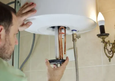 A plumber is installing a tankless water heater in san jose
